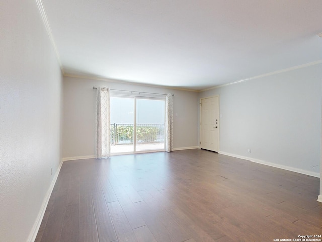 unfurnished room featuring crown molding and dark hardwood / wood-style floors