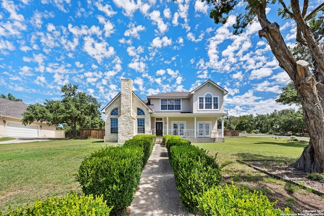 view of front of home with covered porch and a front lawn