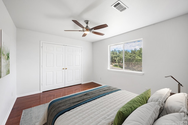 bedroom featuring a closet, ceiling fan, and dark wood-type flooring