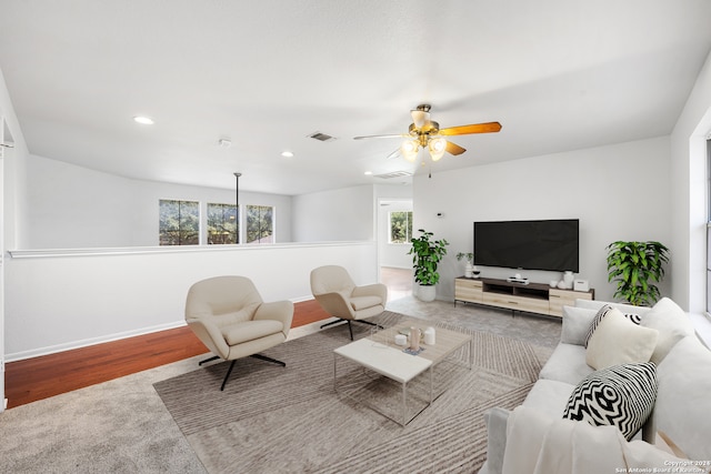 living room with hardwood / wood-style flooring and ceiling fan