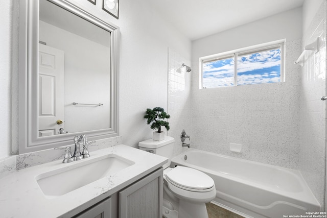 full bathroom featuring vanity, tiled shower / bath combo, and toilet