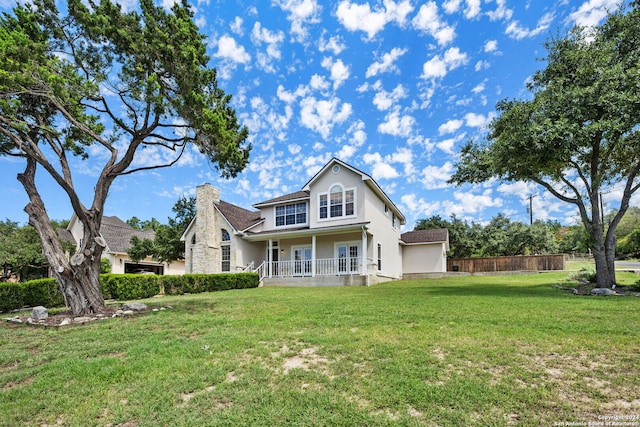 view of front facade featuring a front lawn and covered porch