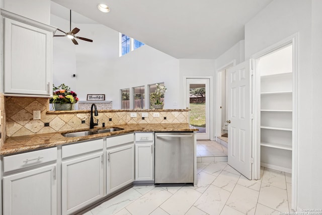 kitchen with backsplash, a wealth of natural light, sink, and stainless steel dishwasher