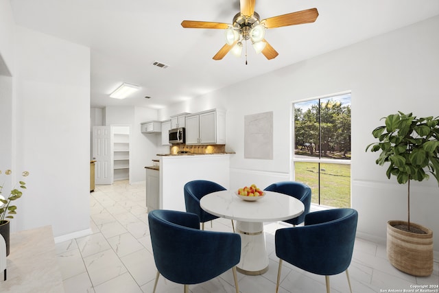 dining space featuring ceiling fan