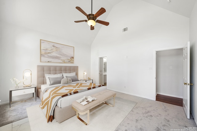 carpeted bedroom featuring ensuite bathroom, high vaulted ceiling, and ceiling fan