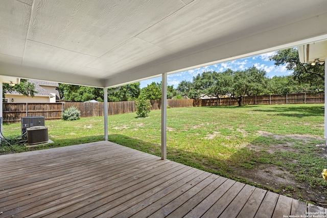 wooden terrace featuring a yard and central air condition unit