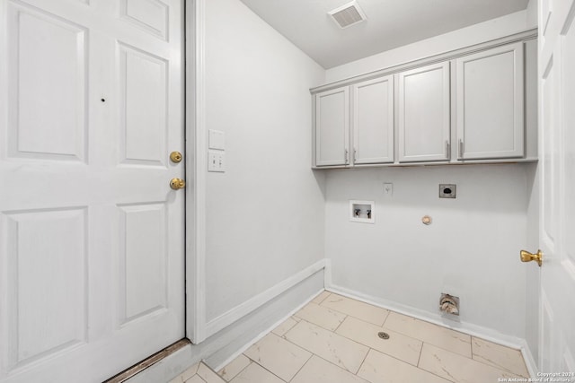 laundry area featuring hookup for an electric dryer, washer hookup, hookup for a gas dryer, and cabinets