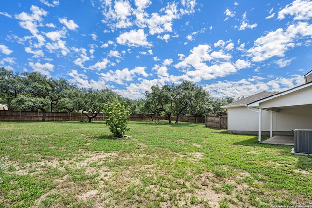 view of yard with a patio and central AC unit