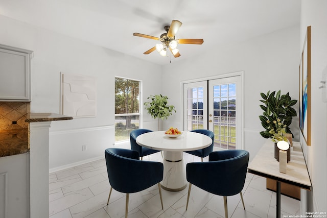 dining space with french doors and ceiling fan