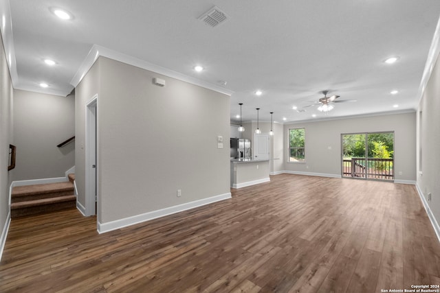 unfurnished living room featuring crown molding, wood-type flooring, and ceiling fan