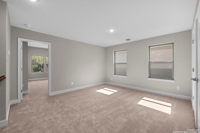 spare room with light colored carpet