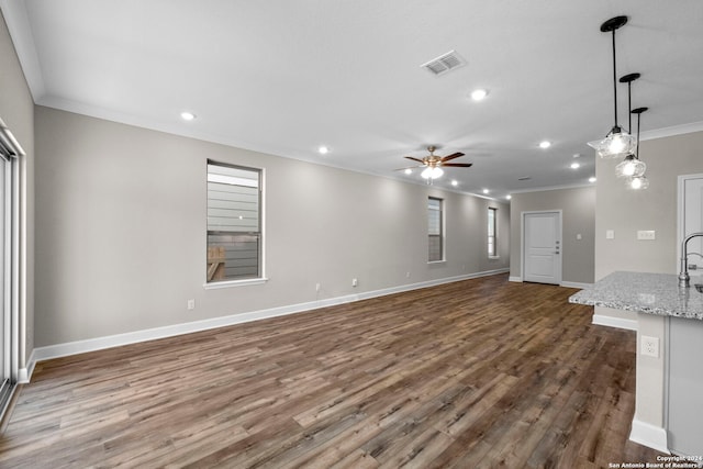 unfurnished living room with crown molding, ceiling fan, and hardwood / wood-style floors