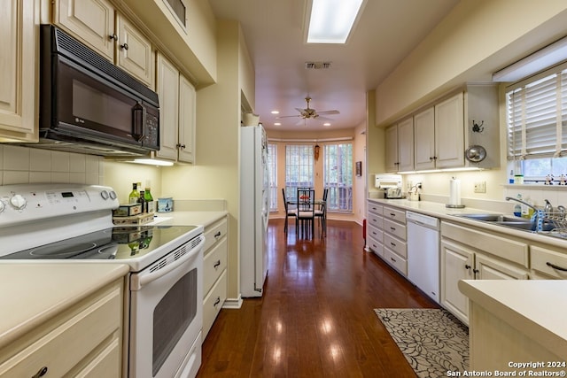 kitchen with dark wood-type flooring, ceiling fan, white appliances, and cream cabinetry