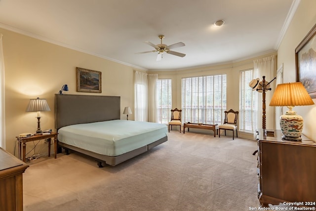 carpeted bedroom featuring crown molding and ceiling fan