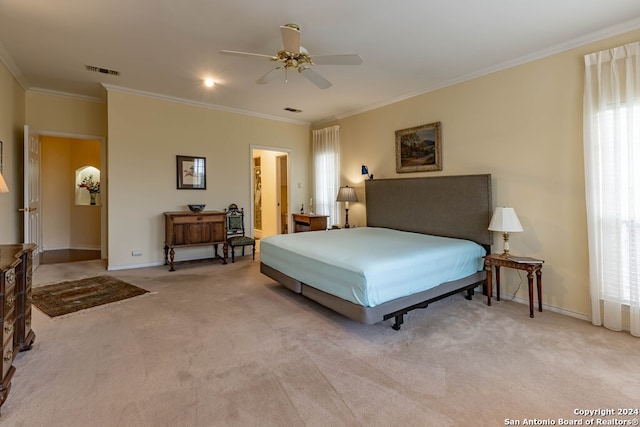 bedroom with ornamental molding, light carpet, and ceiling fan