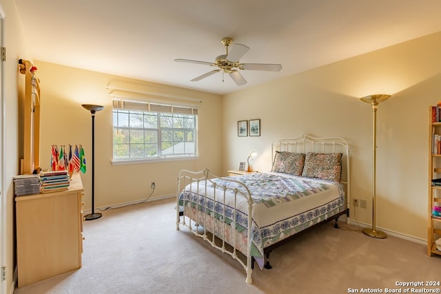 bedroom featuring ceiling fan and light carpet