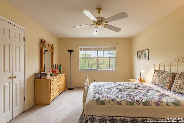 bedroom featuring a closet, ceiling fan, and light carpet