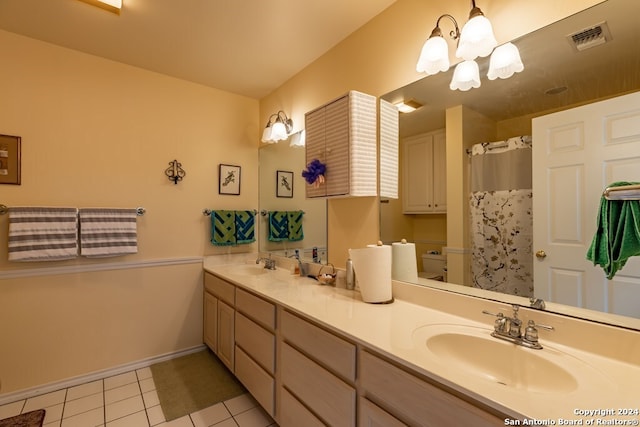 bathroom featuring a chandelier, vanity, tile patterned floors, and walk in shower