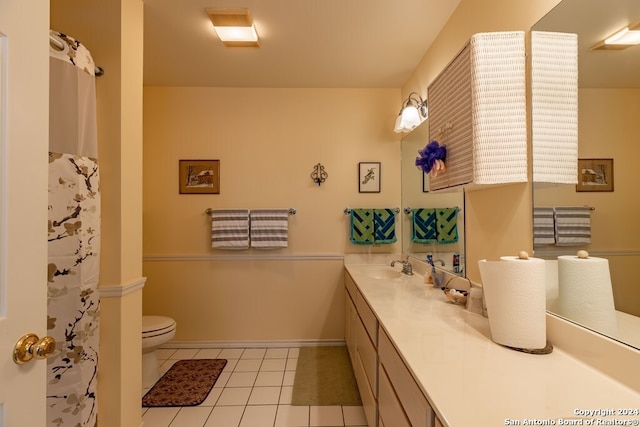 bathroom with vanity, toilet, and tile patterned flooring