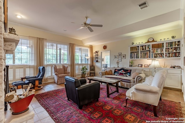 living room with ceiling fan, ornamental molding, light tile patterned floors, and a fireplace