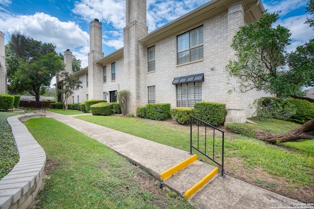 view of property's community with a lawn