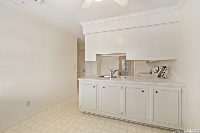 kitchen with white cabinets, sink, ceiling fan, range, and ornamental molding