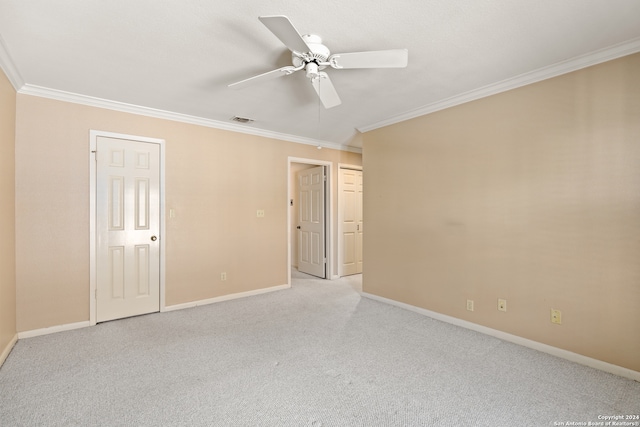 unfurnished bedroom featuring crown molding, light colored carpet, and ceiling fan