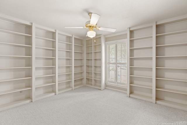 spacious closet featuring ceiling fan and carpet flooring