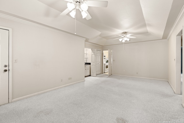 spare room with ornamental molding, a raised ceiling, light colored carpet, and ceiling fan