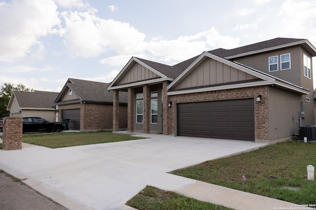 view of front of property with a garage, a front yard, and cooling unit