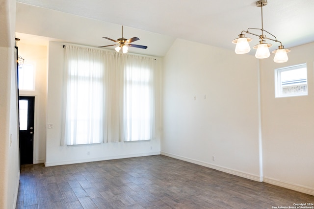 unfurnished room with ceiling fan with notable chandelier, hardwood / wood-style flooring, and plenty of natural light