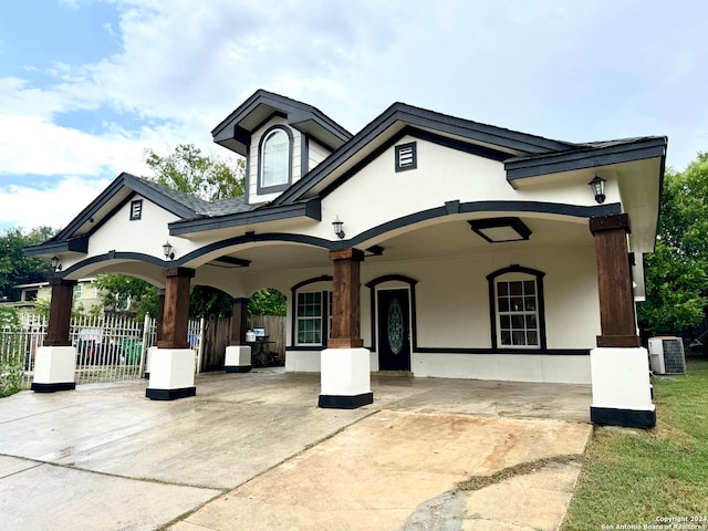 french country inspired facade featuring a porch and central AC