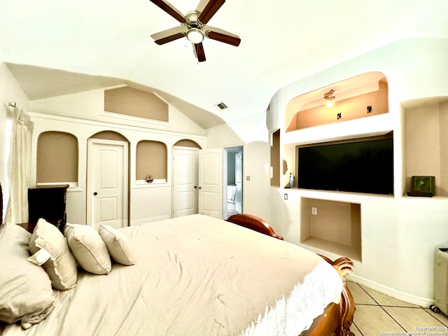 bedroom with vaulted ceiling, light tile patterned floors, and ceiling fan