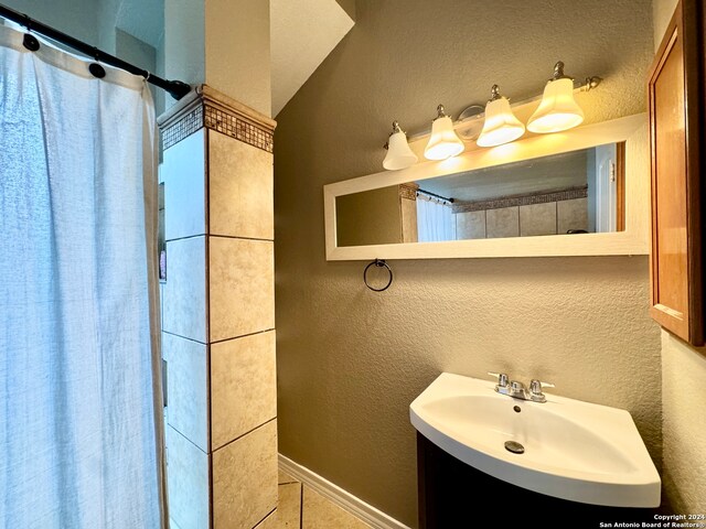 bathroom featuring tile patterned flooring, vanity, and a shower with curtain