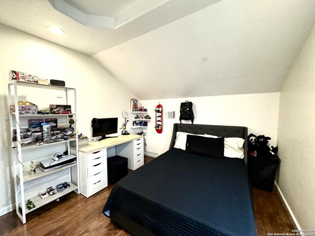 bedroom featuring vaulted ceiling and dark hardwood / wood-style floors