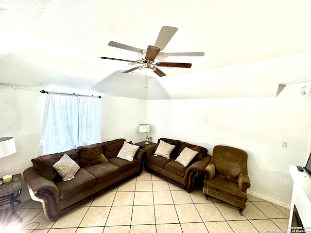 tiled living room featuring ceiling fan, vaulted ceiling, and a textured ceiling