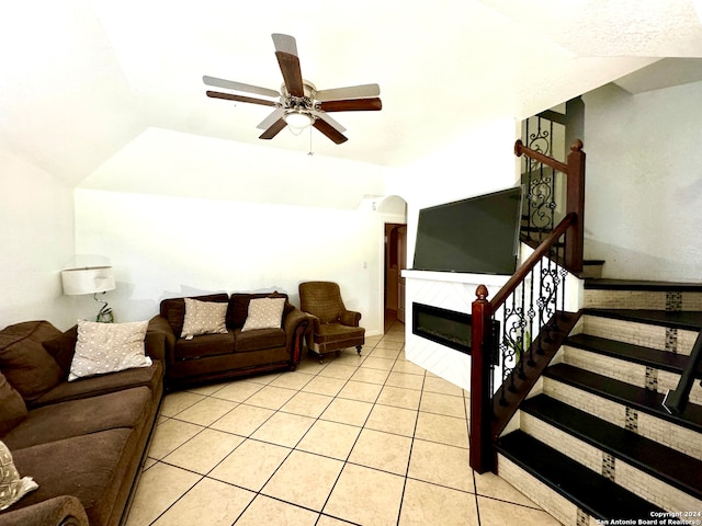 tiled living room featuring lofted ceiling and ceiling fan