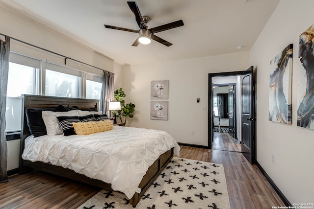 bedroom with dark wood-type flooring and ceiling fan