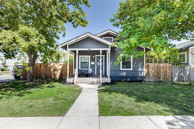 bungalow-style house with a front yard