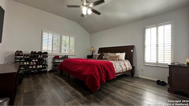 bedroom featuring wood finished floors, a ceiling fan, baseboards, and vaulted ceiling