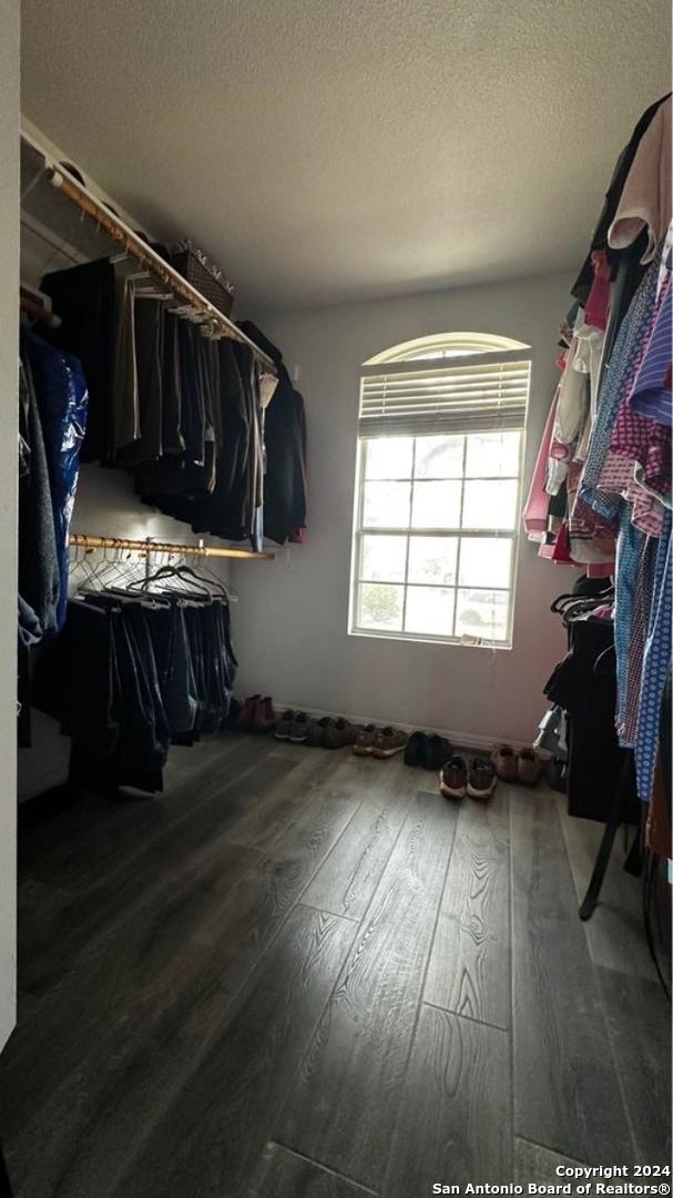 walk in closet featuring wood finished floors