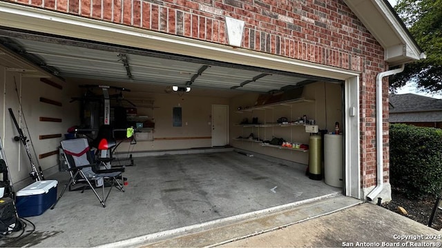 garage with electric panel and a garage door opener