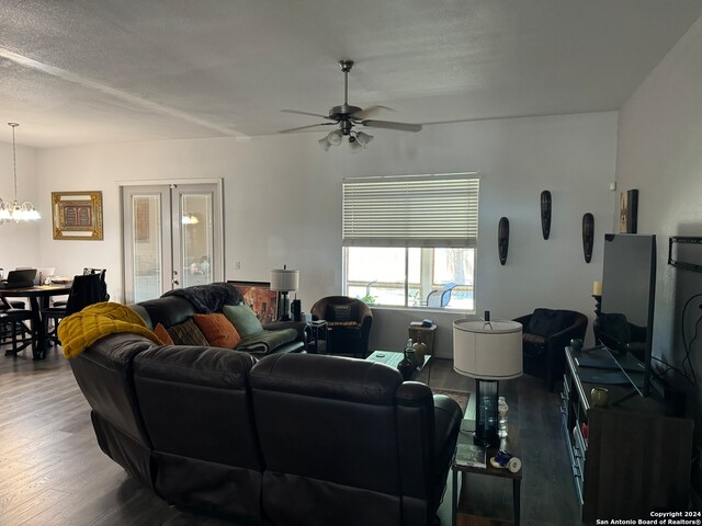 living room featuring a textured ceiling, ceiling fan with notable chandelier, and hardwood / wood-style flooring