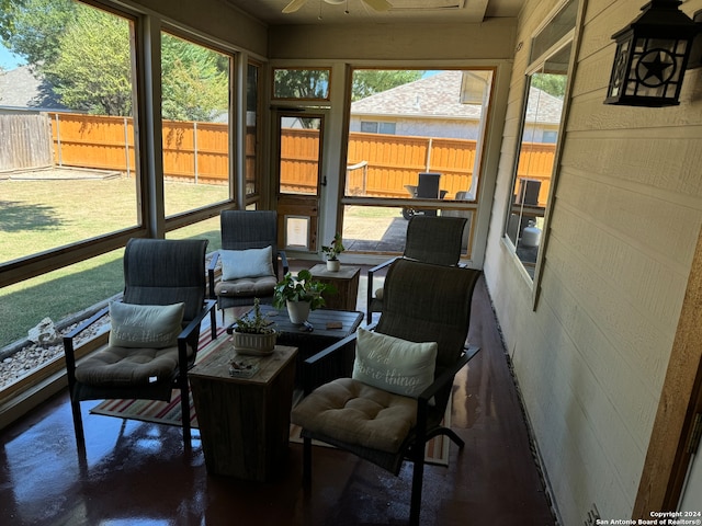 sunroom / solarium featuring a wealth of natural light and ceiling fan