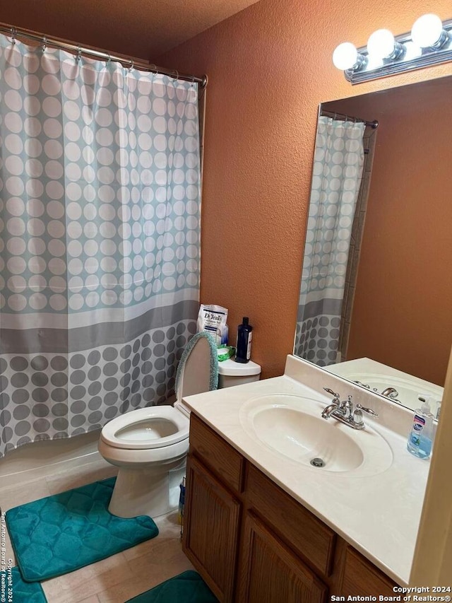 bathroom with a shower with shower curtain, toilet, and vanity