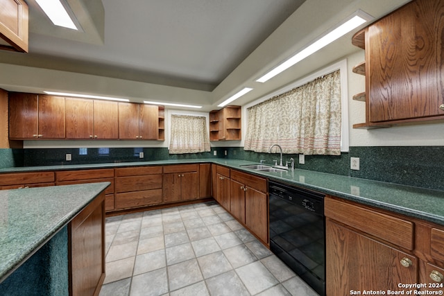 kitchen featuring dishwasher, light tile patterned flooring, and sink