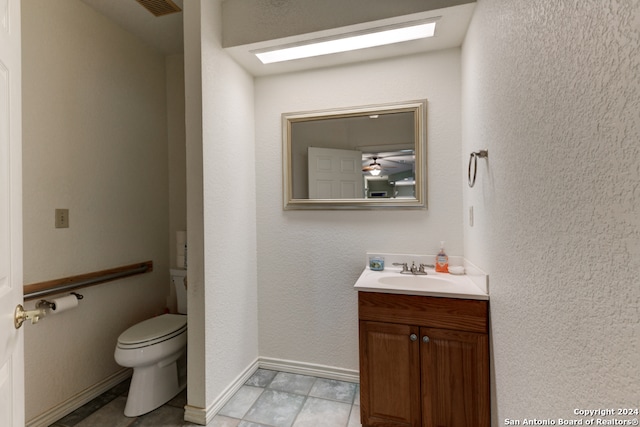 bathroom with tile patterned floors, vanity, and toilet