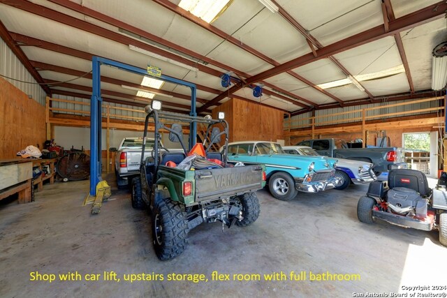 garage featuring wood walls