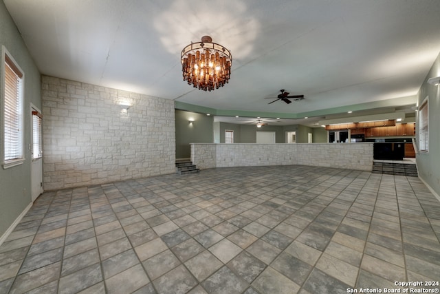 interior space with ceiling fan with notable chandelier