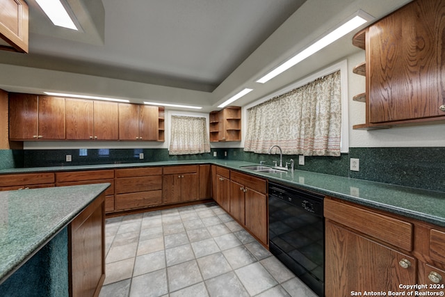 kitchen featuring dishwasher, light tile patterned floors, and sink